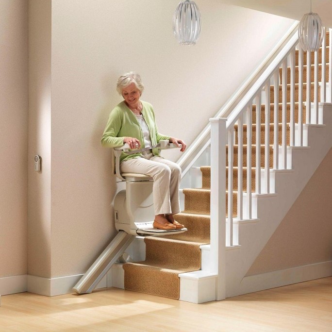 Lady riding Straight Indoor Stairlift